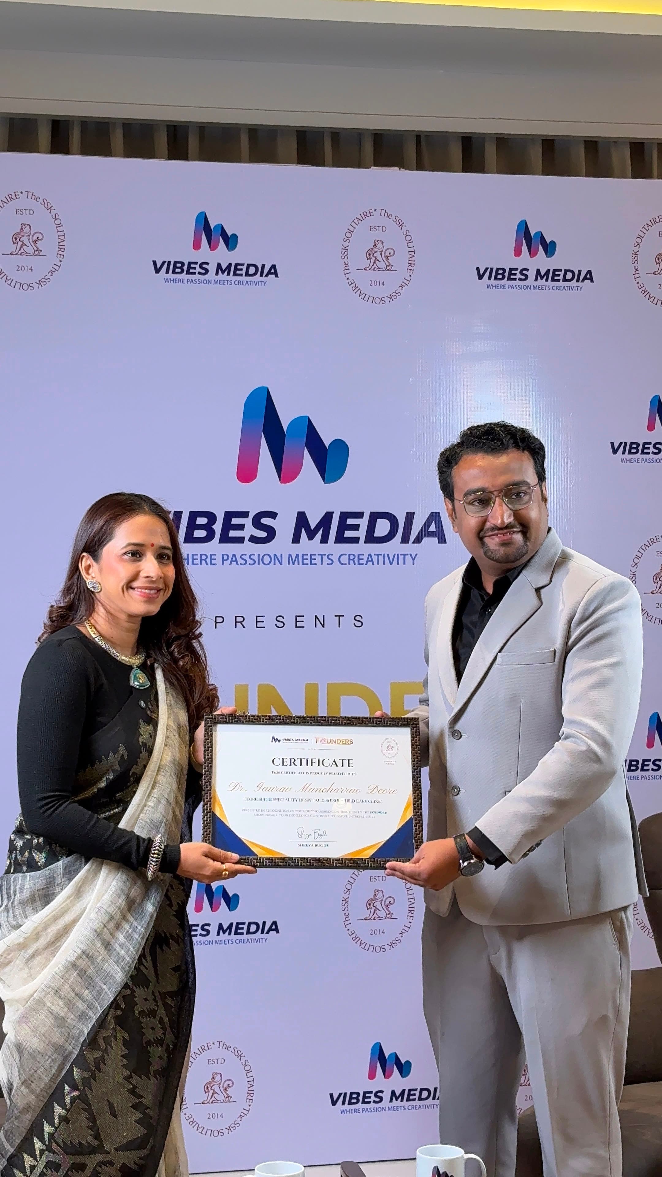 Dr. Gaurav Deore being recognised with celebrity host Shreya Bugde at a Vibes Media event