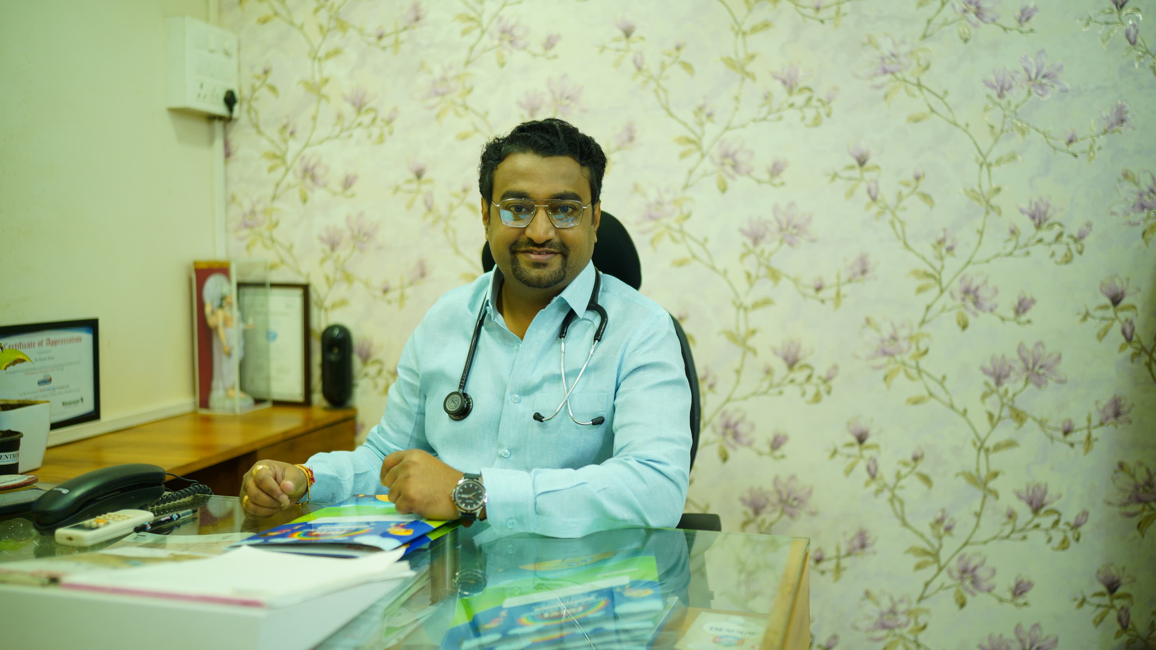 Dr. Gaurav Deore (MD Pediatrics) seated at his consultation desk at Shishu Child Care Clinic